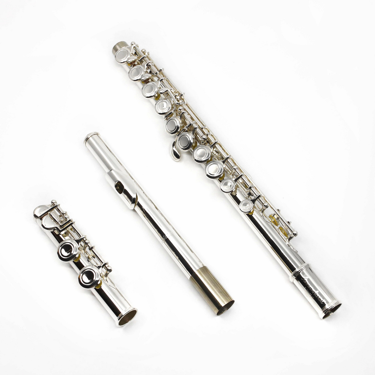 A Gemeinhardt student flute model 2SP disassembled into three pieces, showing the silver-plated headjoint, body, and mechanism with closed holes.