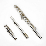 A Gemeinhardt student flute model 2SP disassembled into three pieces, showing the silver-plated headjoint, body, and mechanism with closed holes.