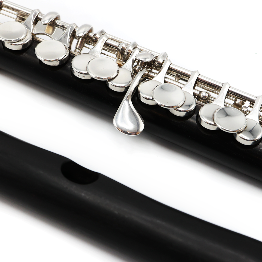 Close-up of a Burkart piccolo Elite #311 with a silver mechanism and a wave style headjoint, made of African Grenadilla wood.